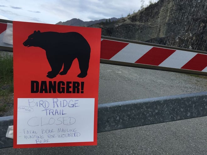 A sign warns people that the trail head is closed on Monday, after a fatal bear mauling at Bird Ridge Trail in Anchorage, Alaska. [AP Photo/Mark Thiessen]