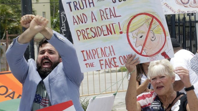 Anti President Donald Trump protesters chants slogans during the president’s visit to the Manuel Artime Theater, Friday, June 16, 2017, in Miami. (AP Photo/Alan Diaz)