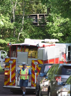 (FILE) One underside of one of the rail cars that rolled of the tracks in Sellersville is seen through the heavy brush as emergency personnel arrive at the scene on Tuesday, June 20, 2017. No one was injured and the cause is being investigated.