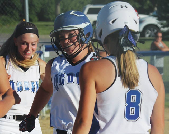 Ogden’s Ashton Boggess, center, is greeted by teammates after hitting a home run last week against Des Moines Christian. The Bulldogs hit 19 homers in their first 20 games this season. (Andrew Logue/News-Republican)