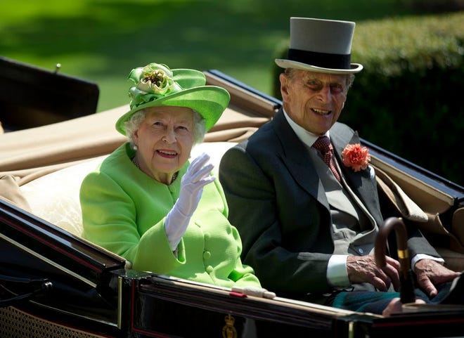 Prince Philip, right, with Queen Elizabeth II, attended the first day of the Royal Ascot horse race on Tuesday, arriving by open carriage. [Alastair Grant/The Associated Press]