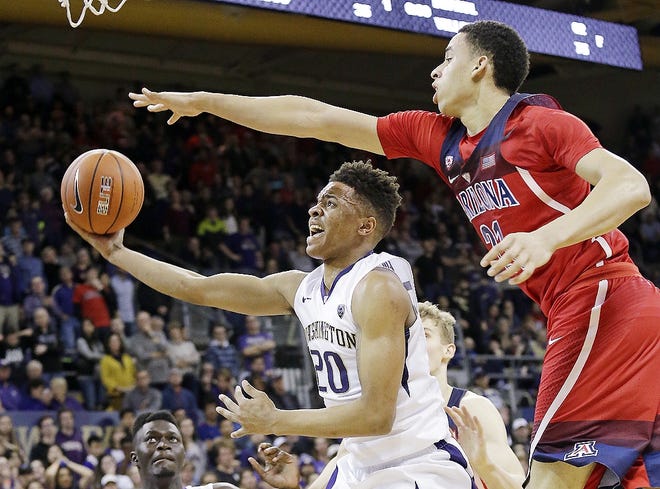 In this Feb. 18 file photo, Arizona's Chance Comanche, right, defends as Washington's Markelle Fultz's (20) looks for a shot during the second half of an NCAA college basketball game, in Seattle. Fultz is the likely No. 1 pick in the NBA Draft on Thursday night. [ELAINE THOMPSON/ASSOCIATED PRESS]