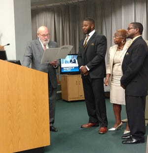 Gastonia Mayor John Bridgeman reads and presents a city proclamation to Ashbrook High School and East Carolina University alum Zeek Bigger, who recently signed a deal to join the Carolina Panthers. Also pictured are Bigger's mother Cathy Barrino, and friend Anthony Adams. Bigger's father, Fred Bigger, is standing behind Adams.[Special to The Gazette]