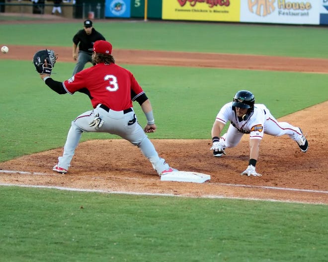 The Wood Ducks' Arturo Lara dives back to first base in a May 25 game against the Carolina Mudcats at Grainger Stadium.