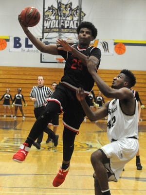 Lincoln forward Andre Kelly, left, scores past West forward Ephraim Estell during a Tri-City Athletic League basketball game on Feb. 1 at Steve Thornton Gym in Tracy. Kelly has received several NCAA Division I offers, including from Cal and Washington State. [CALIXTRO ROMIAS/RECORD FILE 2017]