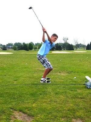 Bhodi Kimmons, 12, of Rockford, practices his swing. Kimmons was one of only a few sixth-grade students to make the All-City Golf team through the Rockford Public Schools. [PHOTO PROVIDED]