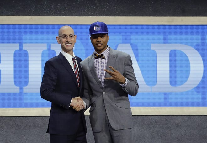 Washington's Markelle Fultz, right, poses for a photo with NBA Commissioner Adam Silver after being selected by the Philadelphia 76ers as the No. 1 pick overall during the NBA basketball draft, Thursday, June 22, 2017, in New York. (AP Photo/Frank Franklin II)
