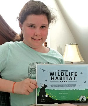 Brooke Macjewski holding her Wildlife Habitat Certificate. SUBMITTED PHOTO