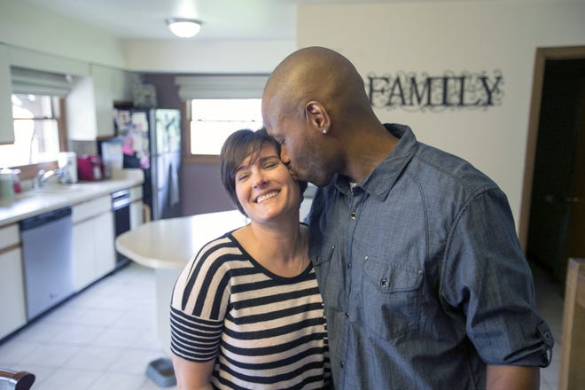 John Horton gives his wife, Melissa, a kiss on the cheek on Monday, May 8, 2017, in the kitchen of their home in Rockford. Horton was in prison for 23 years for murder before being released, but he may face a new trial. [ARTURO FERNANDEZ/RRSTAR.COM STAFF]