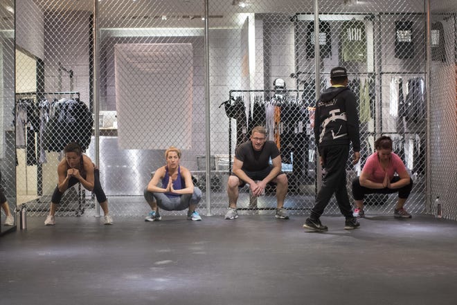 Coss Marte, second from right, conducts a workout class at ConBody Bootcamp Studio at The Wellery on the second floor of the Saks Fifth Avenue flagship store in New York recently. [THE ASSOCIATED PRESS / MARY ALTAFFER]