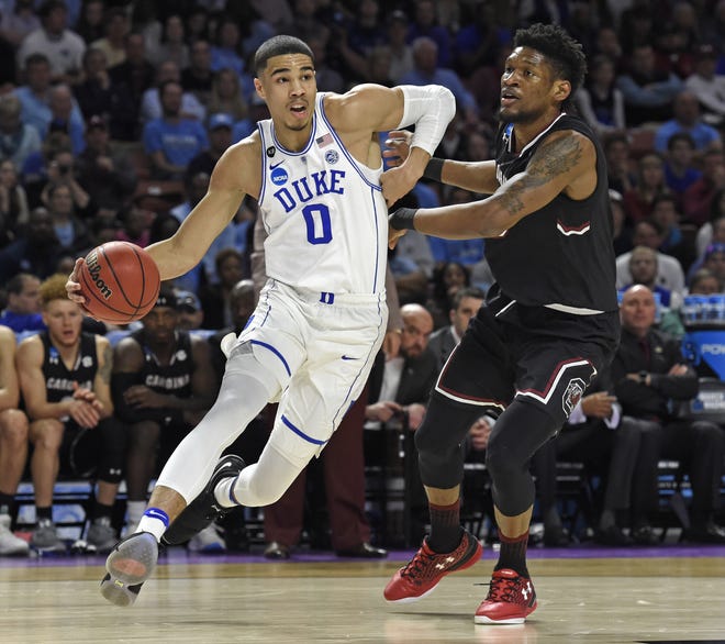 FILE - In this March 19, 2017, file photo, Duke's Jayson Tatum, left, drives past South Carolina's Chris Silva during the first half in a second-round game of the NCAA men's college basketball tournament, in Greenville, S.C. Tatum spent one season at Duke and is expected to be a top-five pick in Thursday's NBA draft. [AP Photo/Rainier Ehrhardt, File]