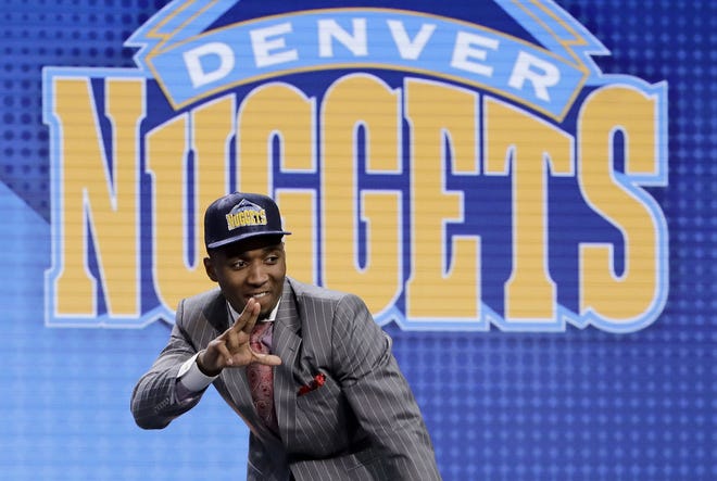 Donovan Mitchell reacts after being selected by the Denver Nuggets as the 13th pick overall during the NBA basketball draft, Thursday, June 22, 2017, in New York. (AP Photo/Frank Franklin II)