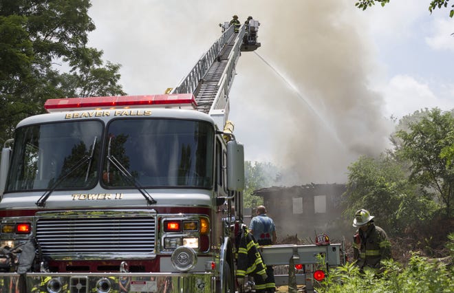 Beaver Falls firefighters work to put out a fire at an abandoned train station Monday.