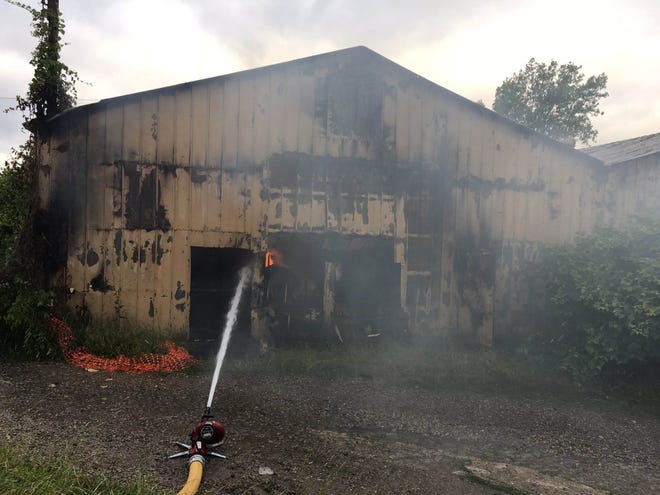 A west Erie warehouse complex under state orders to be cleaned up following a 2016 fire that leveled a large, mattress-filled series of buildings was again the site of a large fire June 23. The complex is located at West 20th Street and Baur Avenue in the city. [TIM HAHN/ERIE TIMES-NEWS]