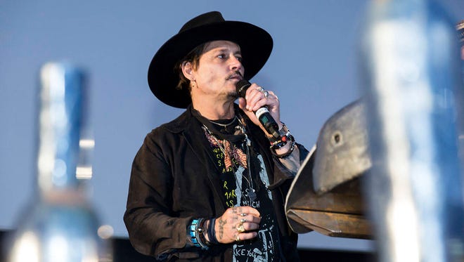 Actor Johnny Depp addresses film goers at the Glastonbury music festival Thursday at Worthy Farm in Somerset, England. (Associated Press)