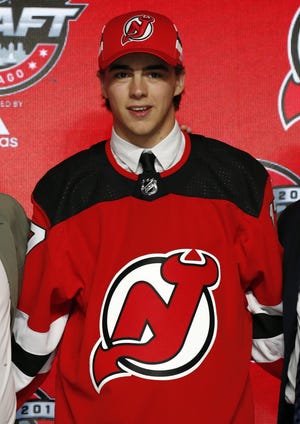 Center Nico Hischier poses in a New Jersey Devils jersey after being selected by the team as the No. 1 overall pick in the NHL Draft on Friday in Chicago. [AP Photo/Nam Y. Huh]