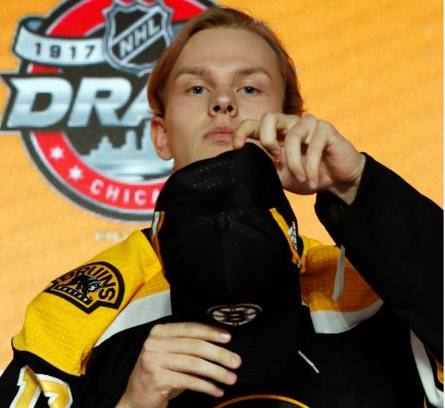 Urho Vaakanainen wears a Boston Bruins jersey after being selected by the team in the first round of the NHL Draft on Friday.