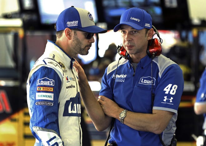 Jimmie Johnson, left, talks with crew chief Chad Knaus earlier this season. Knaus had a laptop with his race notes on it stolen Wednesday. [THE ASSOCIATED PRESS]