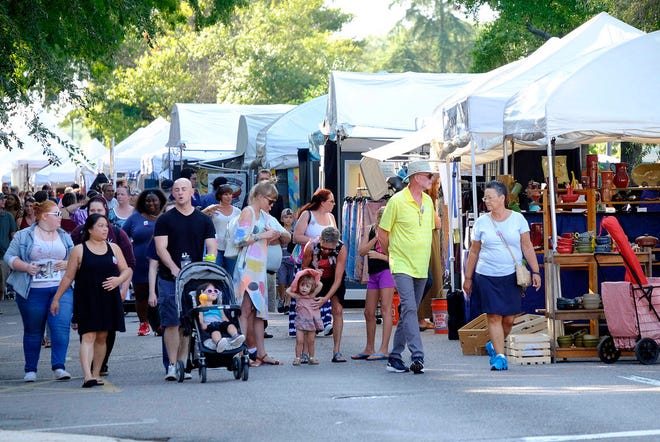 People wander through the fine arts booths during the 2016 Arts in the Heart of Augusta festival. Now in its 37th year, the three-day event draws more than 80,000 attendees. Badges will go on sale in early August. FILE/STAFF
