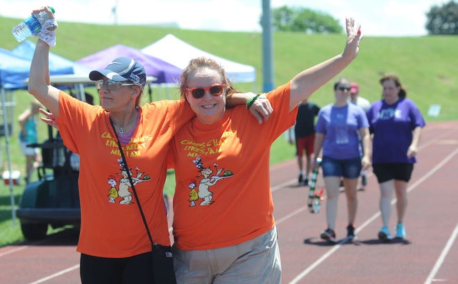 Members of Camps Champs Jen Dinnis (left), of Warrington, and Bonnie Connelly, of Sellersville, walk around the track of the football stadium during the Relay for Life on Saturday June 24, 2017, at Bensalem High School in Bensalem.