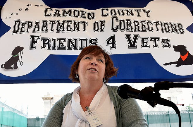 Sherri Smith, of One Love Animal Rescue, addresses those in attendance at the graduation of the first two dogs to go through the Friends 4 Vets program.
