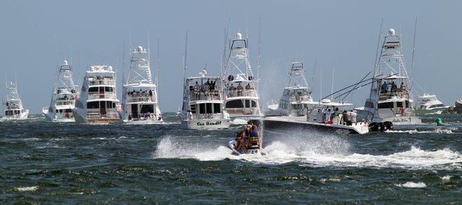 Entrants in the Emerald Coast Blue Marlin Classic head out through the East Pass into the Gulf of Mexico to kick off the tournament. [MICHAEL SNYDER/DAILY NEWS]