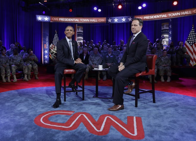 President Barack Obama pauses with CNN news anchor Jake Tapper during break in the taping of a CNN town hall meeting on Sept. 28, 2016, in Fort Lee, Va. [CAROLYN KASTER/AP]