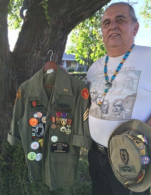 Joe Maes with his decorated U.S. Army jacket and memorabilia from his service in Vietnam. [LORI GILBERT/THE RECORD]