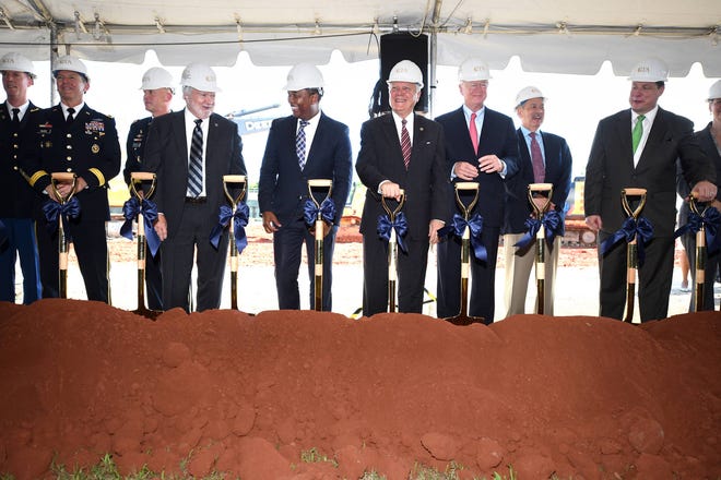 MICHAEL HOLAHAN/STAFF Gov. Nathan Deal (middle in striped tie) leads a contingent of dignitaries in the ceremonial groundbreaking for the Georgia Cyber Innovation and Training Center in Augusta on Monday.
