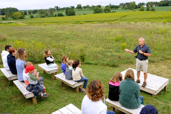 In this 2015 photo, Jim Reding explains the history of the Land Lab classroom at Granville Intermediate School in Granville, Ohio. Reding, a high school science teacher said climate change is an issue that will affect his students’ lives and he wants them to think critically and have civil, reasoned conversations about it.