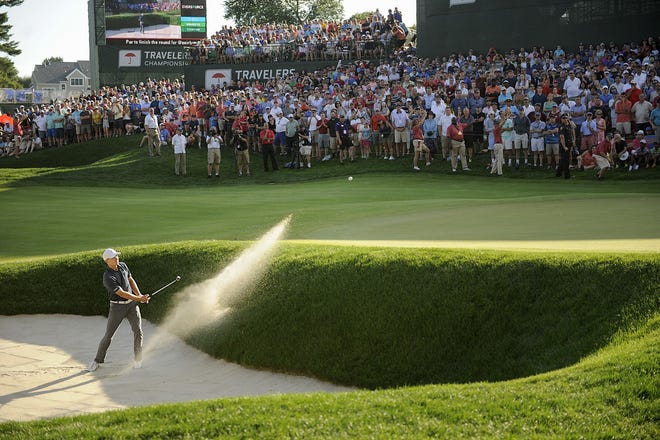Jordan Spieth holed his bunker shot on the 18th green for a birdie and win over Daniel Berger during the final round of the Travelers Championship on Sunday. [John Woike/Hartford Courant via AP]