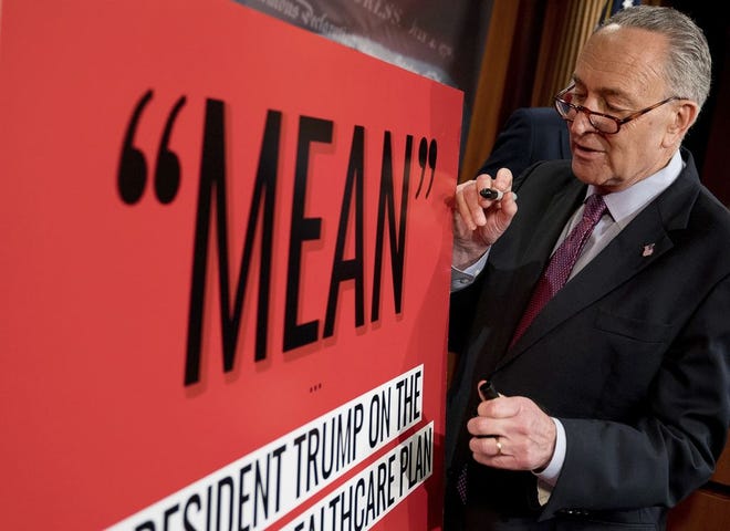 Senate Minority Leader Chuck Schumer, D-N.Y., writes "Mean-er" on a reported quote by President Donald Trump as Schumer responds to the release of the Republicans' healthcare bill which represents the long-awaited attempt to scuttle much of President Barack Obama's Affordable Care Act, at the Capitol in Washington, Thursday, June 22, 2017. (AP Photo/Andrew Harnik)