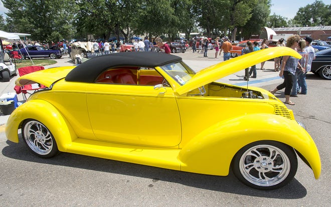 CHIEFTAIN PHOTOS/JOHN JAQUES A bright yellow 1939 Ford ConvertIble owned by Denny Day from Wakeeney, Kan., is parked at the 33rd Rocky Mountain Street Rod Nationals at the Colorado State Fairgrounds on Saturday.