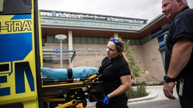 An ambulance makes its way to the Dell Seton Medical Center at the University of Texas.