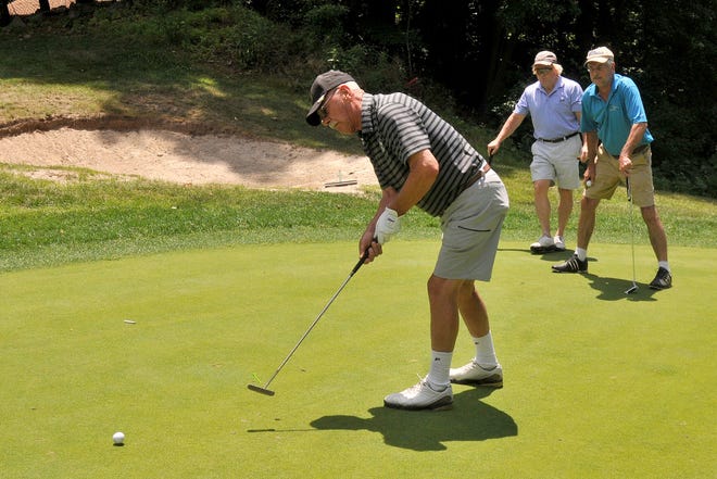 Dick Stahl, 78, of Medford Lakes putts during the 17th annual Gordon-Masters Golf Tournament at Rancocas Golf Club on Monday, June 26, 2017. Glenn Smith and John Baingo watch as Stahl putts.