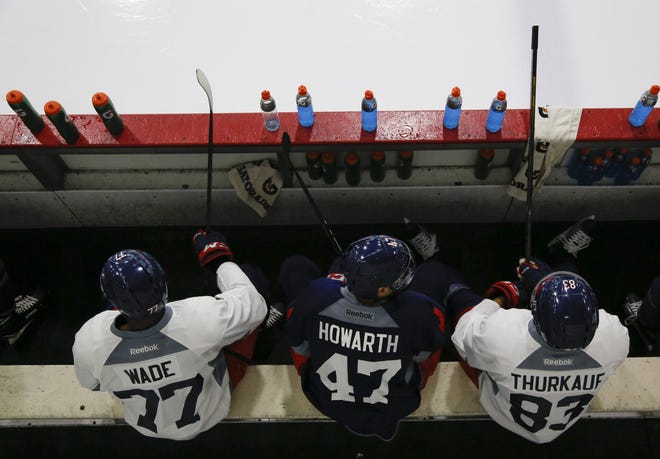 Blue Jackets defenseman Justin Wade, left, forward Kale Howarth, middle, and forward Calvin Thurkauf wait for practice to start during development camp at the Ice Haus. [Joshua A. Bickel/Dispatch]