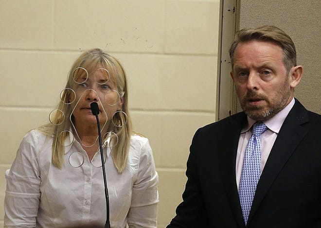 Kristen Smith, 53, of Brockton at her arraignment for murder with her lawyer Brian Kelley at Brockton District Court on Monday, June 26, 2017.