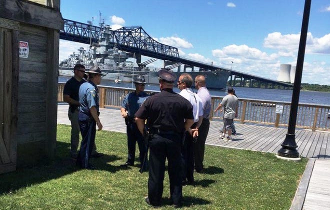 Authorities meet Monday in Fall River, near where the body of a likely suicide victim was discovered. [Linda Murrphy/The Herald News]
