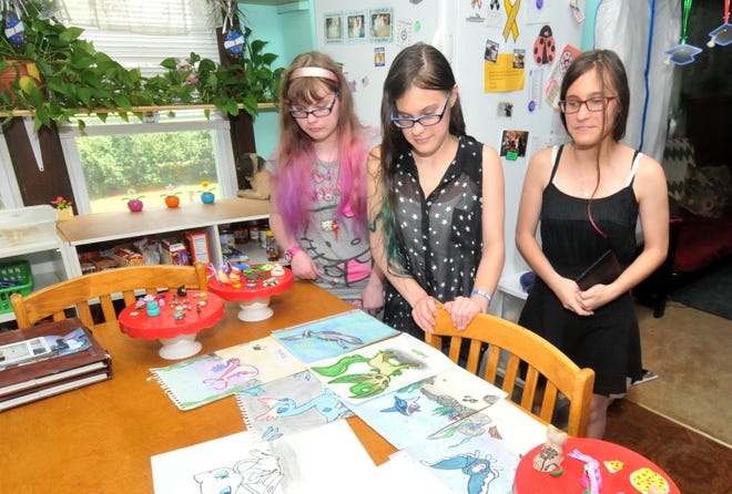 The Volkman triplets — (from left) Amanda, Ashley and Anita — talk about their artwork at their Riverside home on Friday, June 23, 2017.
