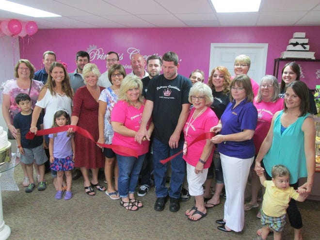 Members of the Canton Area Chamber of Commerce Ambassador Club join with staff of Princess Creations for their grand opening and ribbon cutting Friday. Also present during the opening was Kuenzl’s godmother from Switzerland.