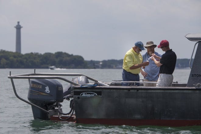 Researchers collect water samples from Lake Erie last year off South Bass Island.