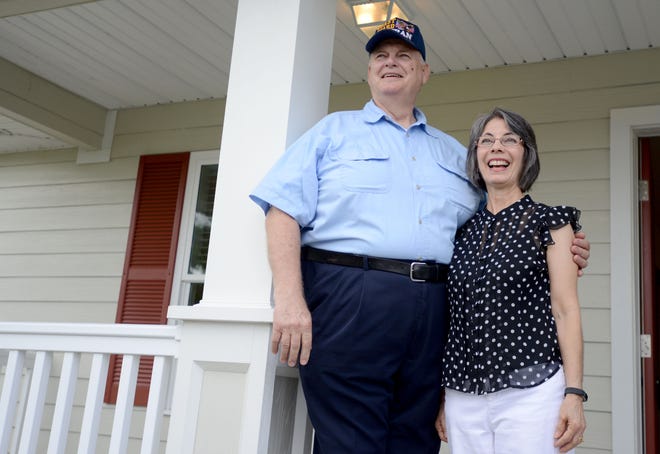 Coast Guard veteran Reed Vonhold and his wife, Michele, stand outside their new home after a dedication ceremony at Veterans Village on Monday in Umatilla. This is the first home that Habitat for Humanity has dedicated in the developing community. [AMBER RICCINTO / DAILY COMMERCIAL]