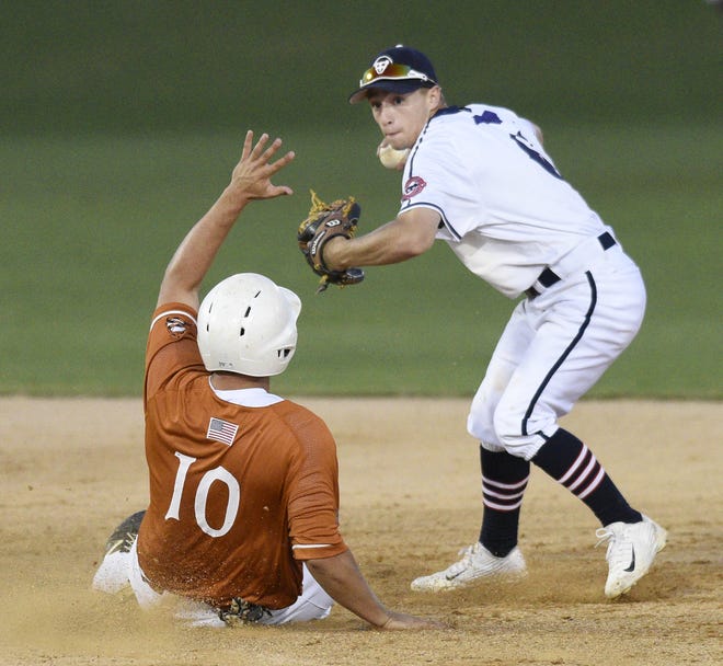 HiToms' Cody Grosse (right) turns a double play while Asheboro's Bryan Blanton slides into second during their game Tuesday evening at Finch Field. [Molly Mathis/The Dispatch]