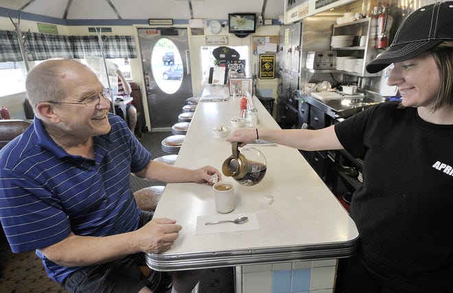 Lawrence Park resident Doug Lasky, 70, gets a coffee refill from April Revak, 26, at the Lawrence Park Dinor on Thursday. [GREG WOHLFORD/ERIE TIMES-NEWS]