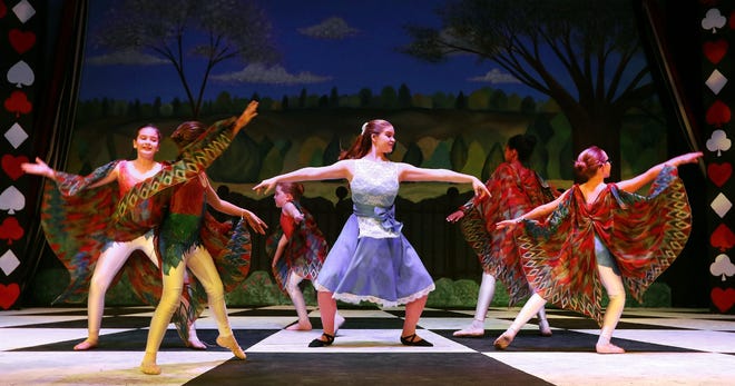 Torrie Epstein (Alice), center, dances with the butterflies during rehearsal for Gaston Dance Theatre's production of "Alice's Adventures in Wonderland" in April. [JOHN CLARK/THE GAZETTE]