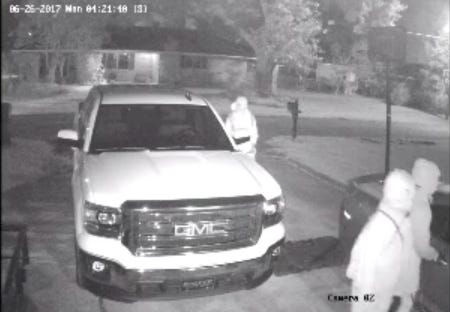 Taken from home surveillance video. Two men appear to be holding handguns.