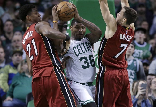 Marcus Smart (36) tries to keep possession while Miami's Hassan Whiteside (21) and Goran Dragic try to steal the ball on March 26.