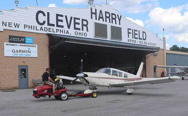 Eric Hubbard puts an airplane in the hanger at Harry Clever Field Tuesday in New Philadelphia. (TimesReporter.com / Jim Cummings)