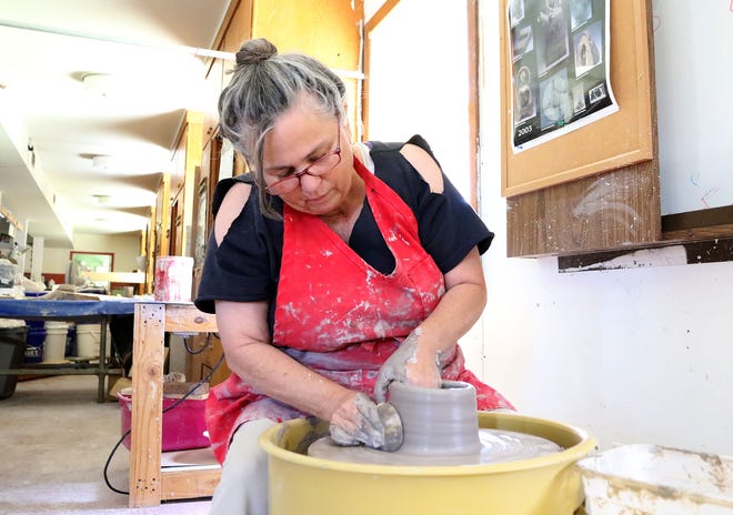 Tammy Pyle Fujibayashi begins sculpting a new bowl on a potter's wheel Monday, June 26, 2017, in the Cre8ive Arts Network studio, 7408 Buckhorn St. in the Chaffee Crossing historic district. A new couples pottery class is now being offered by appointment. [JAMIE MITCHELL/TIMES RECORD]