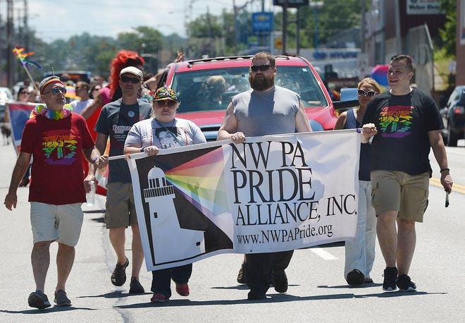 Members of the NW PA Pride Alliance lead the PrideFest march June 24 at 18th and State streets. [JACK HANRAHAN/ERIE TIMES-NEWS]